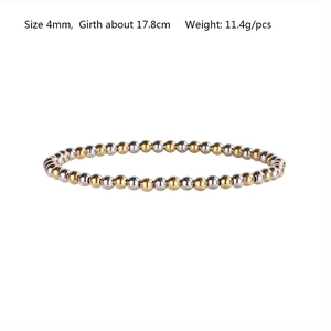 Close-up of a two-tone stretch bracelet with 4mm silver and gold beads on white background