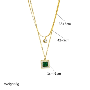 Double layered gold necklace with square emerald green pendant and sparkling round rhinestones