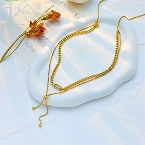 Gold double-layered necklace with rectangular pendant and adjustable slider chain