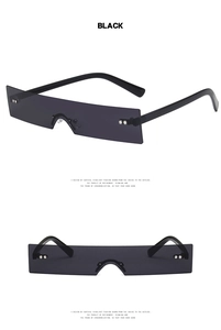 Detail view of narrow rectangular rimless sunglasses with black lenses and metal rivets