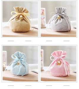 Detail of velvet wedding candy bags with pearl Double Happiness charms and silk ribbons