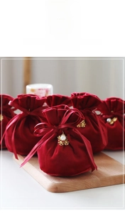 Macro shot of red velvet wedding candy bags with gold double happiness charms