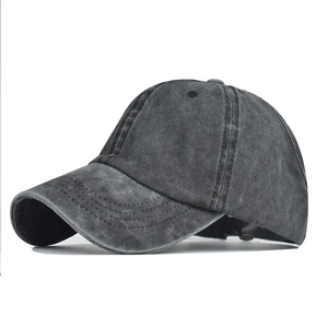 Detail of washed cotton ponytail baseball cap in charcoal grey with curved visor