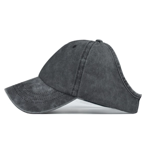 Side view of dark gray washed denim ponytail baseball cap showing the back opening detail