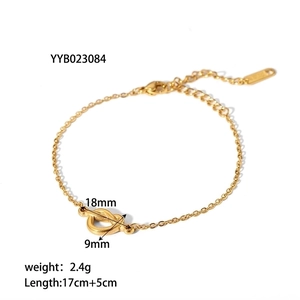 Detail of gold-plated heart knot pendant with size dimensions 18mm by 9mm and lobster clasp