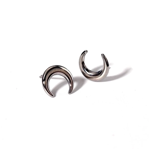 Close-up of crescent-shaped stainless steel stud earrings with silver mirror finish
