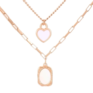 Double layered necklace in rose gold with heart and oval pendants on a white background