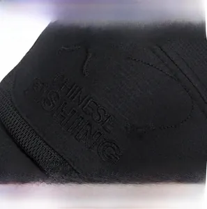 Macro shot of black outdoor fishing hat featuring high-density embroidery and tech fabric
