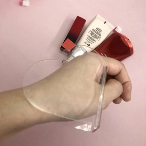 Macro view of heart-shaped acrylic makeup palette with finger hole for mixing foundation