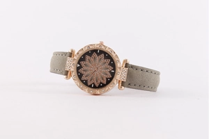 Detailed view of women's quartz watch with black starry dial and floral rhinestone design