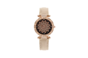 Detailed close-up of rose gold starry sky watch face with rotating crystal flower design