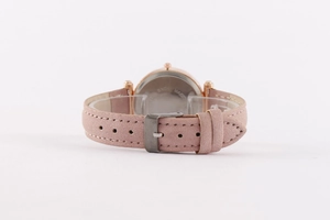 Detail of pink faux leather watch strap with rose gold buckle and steel case back