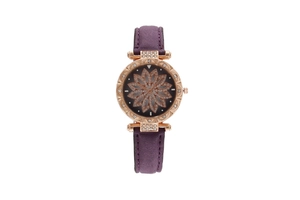 Detail of rose gold watch case with crystal accents and purple suede leather strap