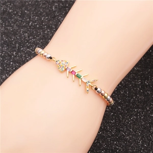 Colorful fishbone bracelet with zircon inlays and tri-color beads on a woman wrist
