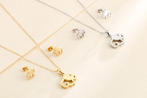 Detailed set of gold and silver hollow elephant necklaces with matching stud earrings
