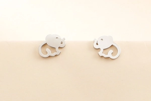 Macro shot of silver hollow elephant stud earrings in polished stainless steel finish