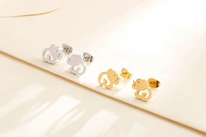 Detailed view of hollow elephant stud earrings in gold and silver stainless steel finish