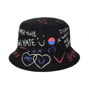 Detailed view of black cotton bucket hat with colorful street graffiti print and slogans