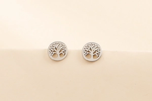 Detailed close-up of silver steel tree of life stud earrings with hollowed design
