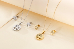 Detailed set of silver and gold tree of life necklaces and matching stud earrings