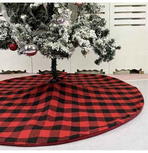 Detailed view of a red and black buffalo plaid Christmas tree skirt decoration