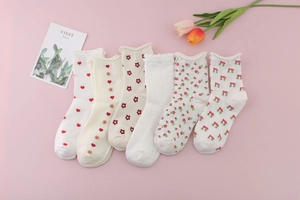 Detailed macro view of 6-pack women's cotton crew socks with red hearts and floral patterns
