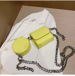 Detail of yellow crocodile pattern mini pouch set with heavy silver metal chain strap