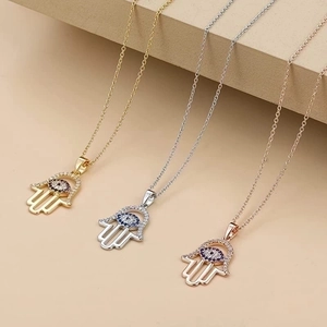 Hamsa Hand and Evil Eye pendant necklaces in gold, silver, and rose gold finish