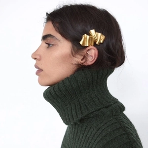 Matte gold irregular wrinkled hair clip styled on a model with minimalist artistic design