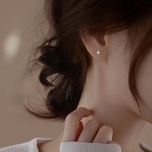 S925 sterling silver four-point star stud earrings with diamond accent on model