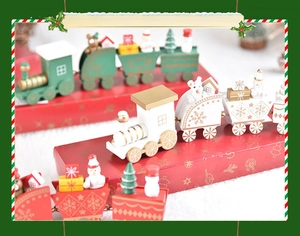 Close-up of wooden Christmas train miniatures with snowman and tree on red gift boxes
