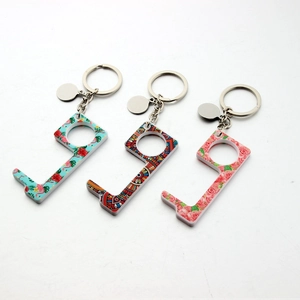 Detailed macro view of three 5mm thick acrylic EDC door opener keychains with floral patterns