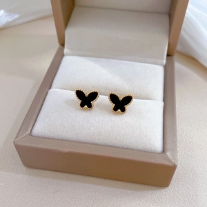 Minimalist black agate butterfly stud earrings in gold titanium steel on jewelry box
