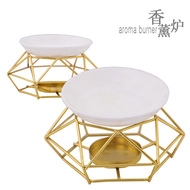 Detail of tulip ceramic aroma burner with gold metal stand and removable oil bowl