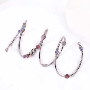 Bohemian multi-layer wrap bracelet featuring imperial stone beads and silver metal charms