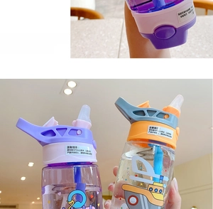 Close-up of children's plastic water bottle with straw, cartoon patterns and handle