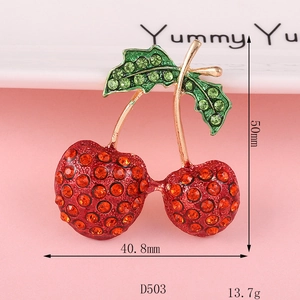 Sparkling cherry brooch with red rhinestones and measurements of 50mm x 40.8mm