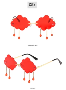 Close-up of red cloud-shaped rimless sunglasses with gold tassels and waterdrop charms