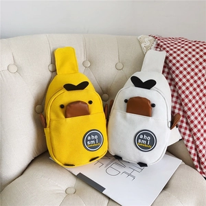 Detailed view of yellow and white cartoon duck canvas chest bags for kids and women
