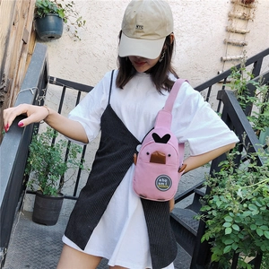 Outdoor model shot of pink canvas duck chest bag worn on stairs for casual style