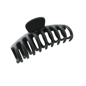 Detailed view of a large black matte half-moon hair claw clip with strong teeth for thick hair