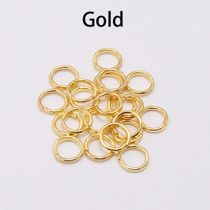Detail view of small gold jump rings for jewelry making and necklace link assembly