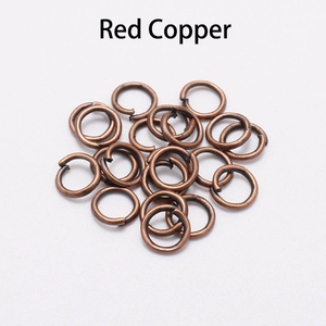 Close-up of red copper open jump rings for jewelry making and necklace connection
