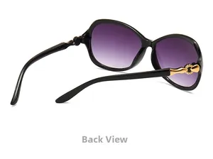 Macro detail of fashionable oval sunglasses showing gold metal hinges and purple gradient lenses