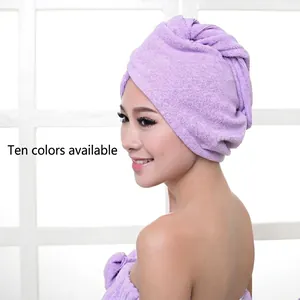 Absorbent microfiber hair drying turban in purple shown on model with window background