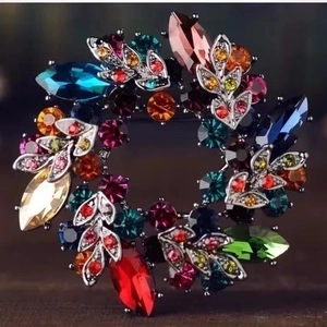 Vintage crystal flower wreath brooch with colorful rhinestones in a silver-tone frame