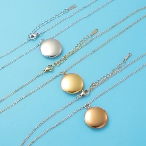 Three round mirror-polished locket necklaces in silver, gold and rose gold tones