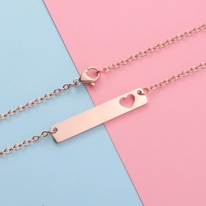 Detailed view of rose gold bar necklace featuring a heart cutout and lobster clasp