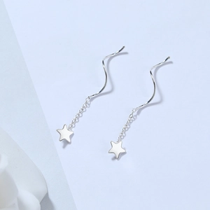 Macro detail of S925 sterling silver star dangle earrings with spiral threader design