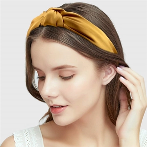 Elegant mustard yellow satin knot headband for women featuring a stylish vintage twisted design